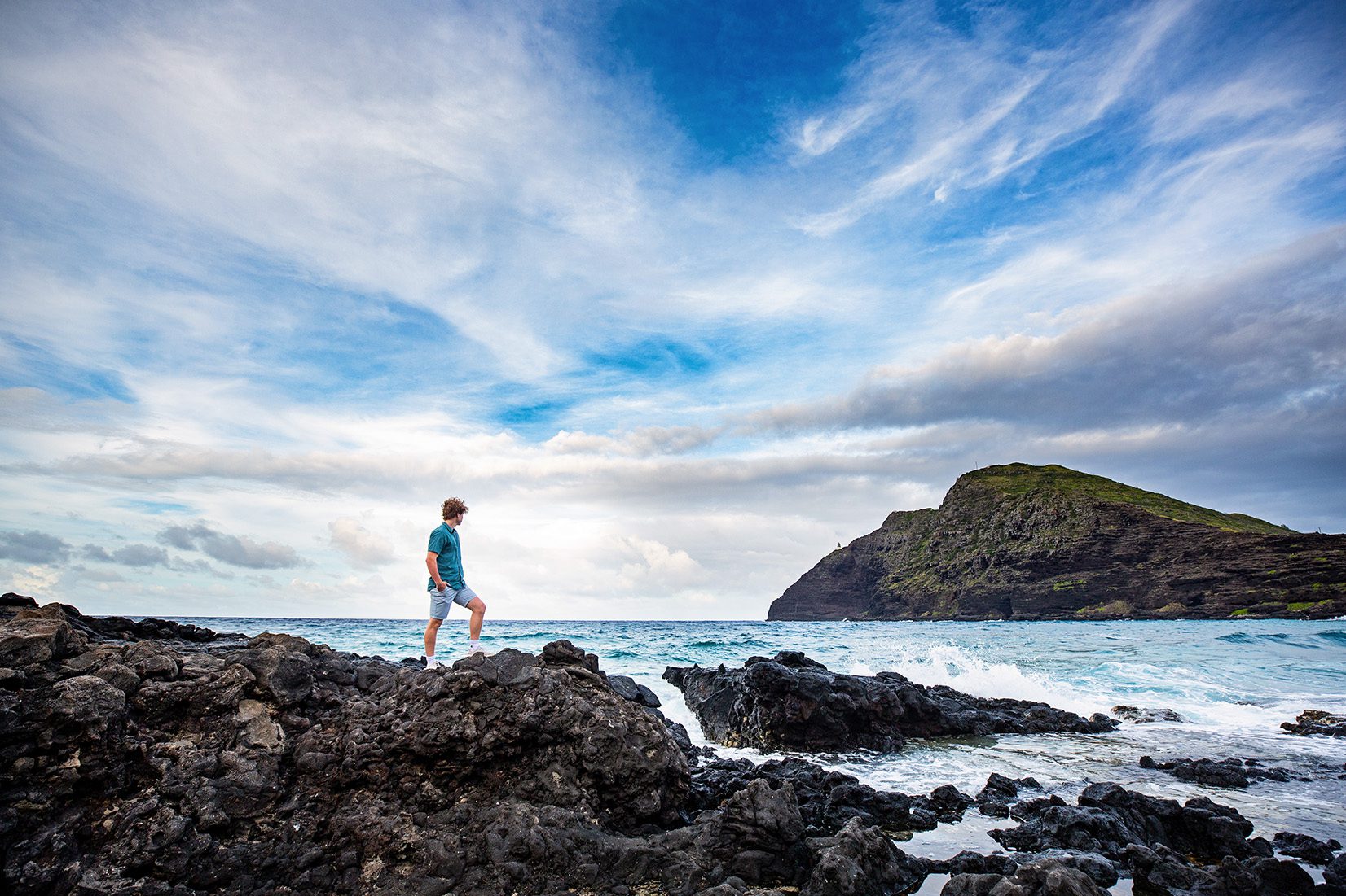 boy senior portrait on a rocky beach in Hawaii