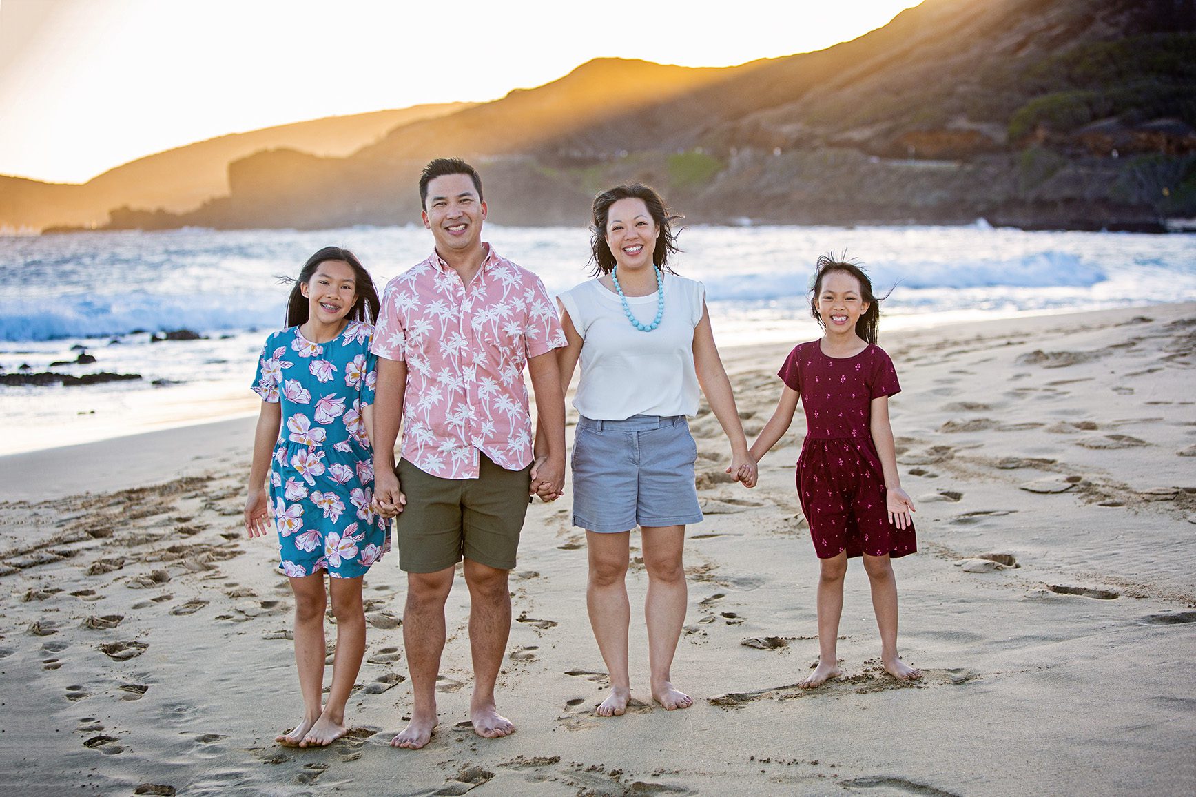 family portrait at sunset on beach in Hawaii